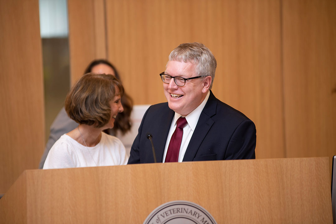 Dean Warnick at a podium congratulating staff service award recipients