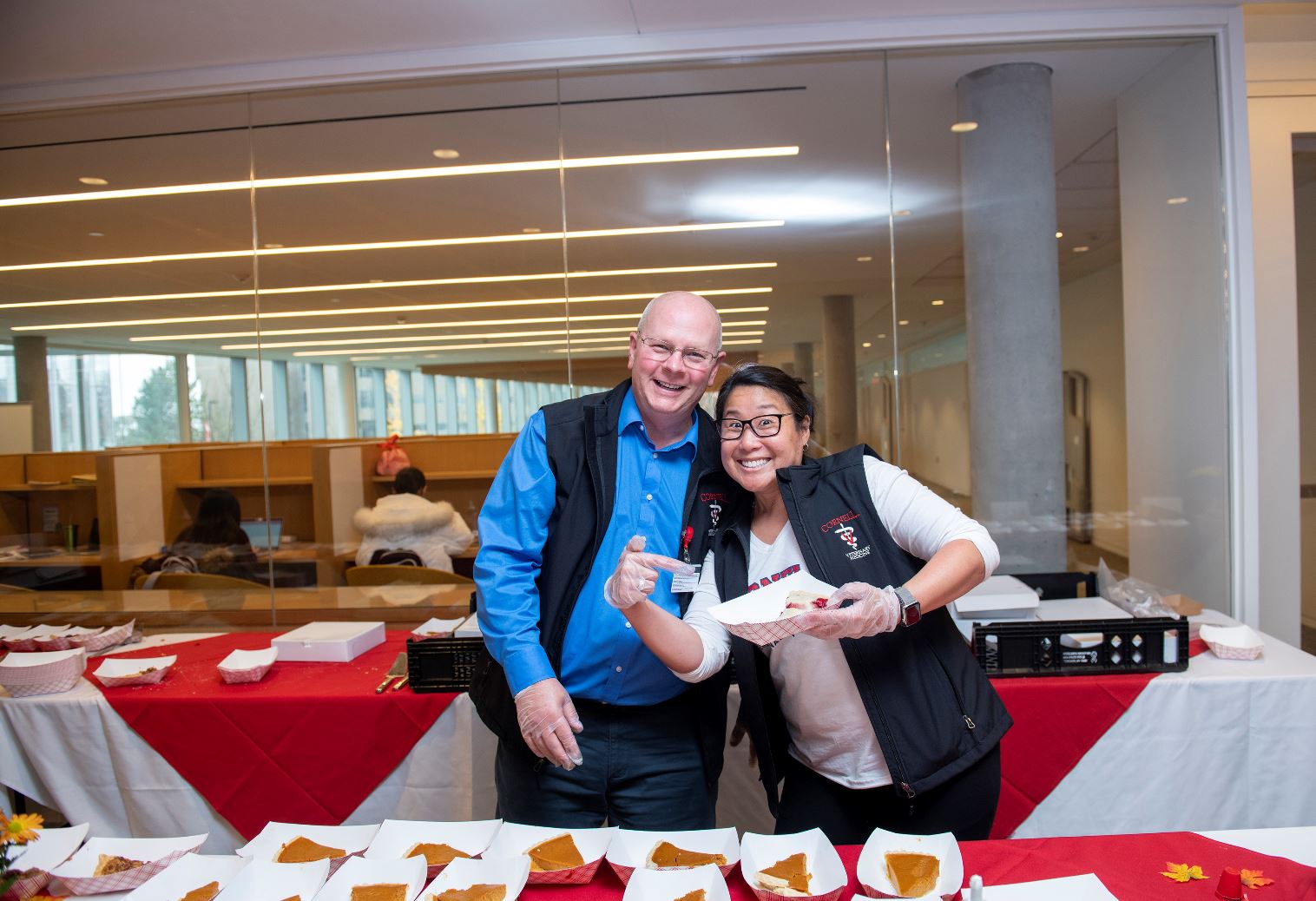 Bob Wakeman and Carolyn Chow of CVM HR serve pie at a CVM event