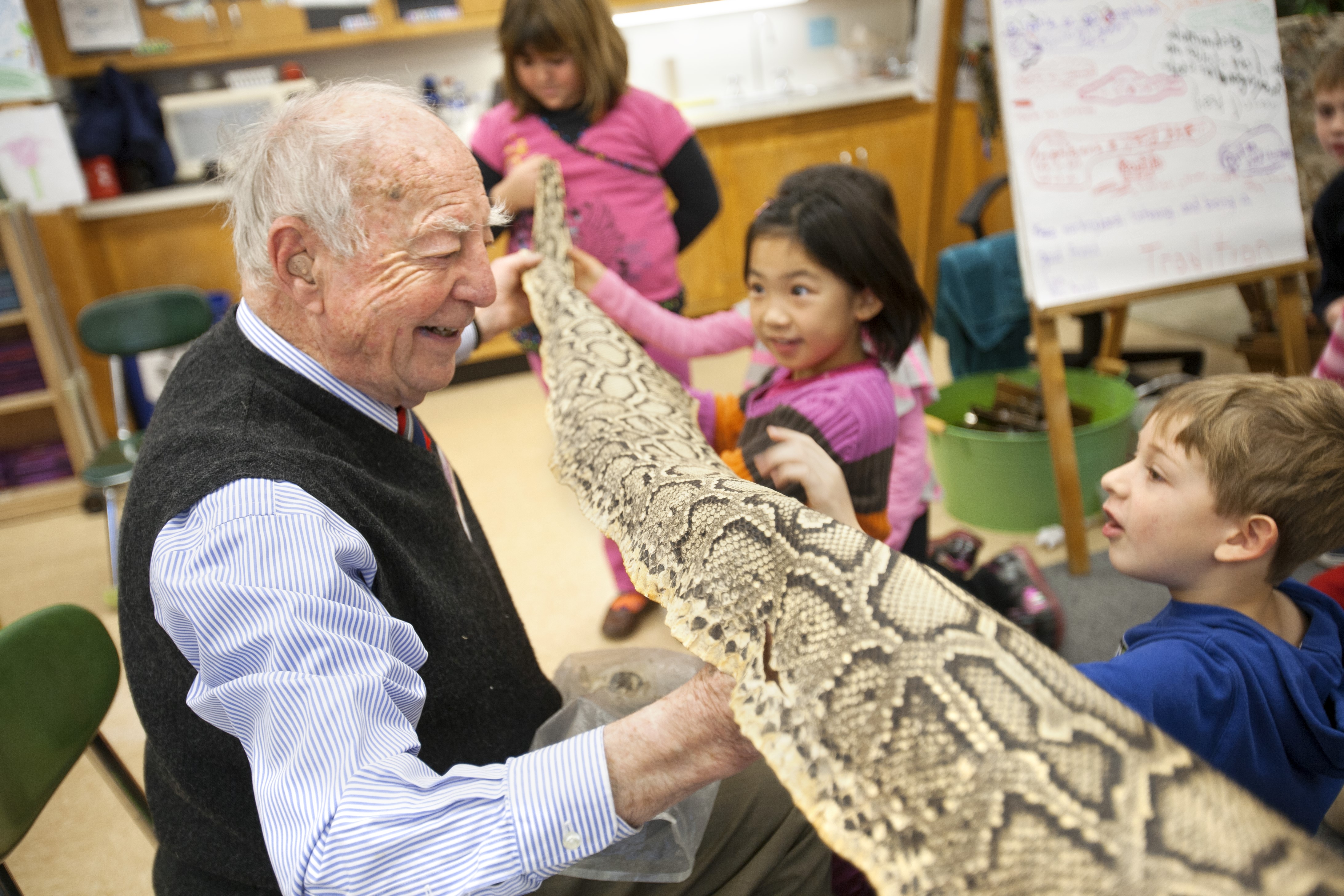 Harold Evans with schoolchildren