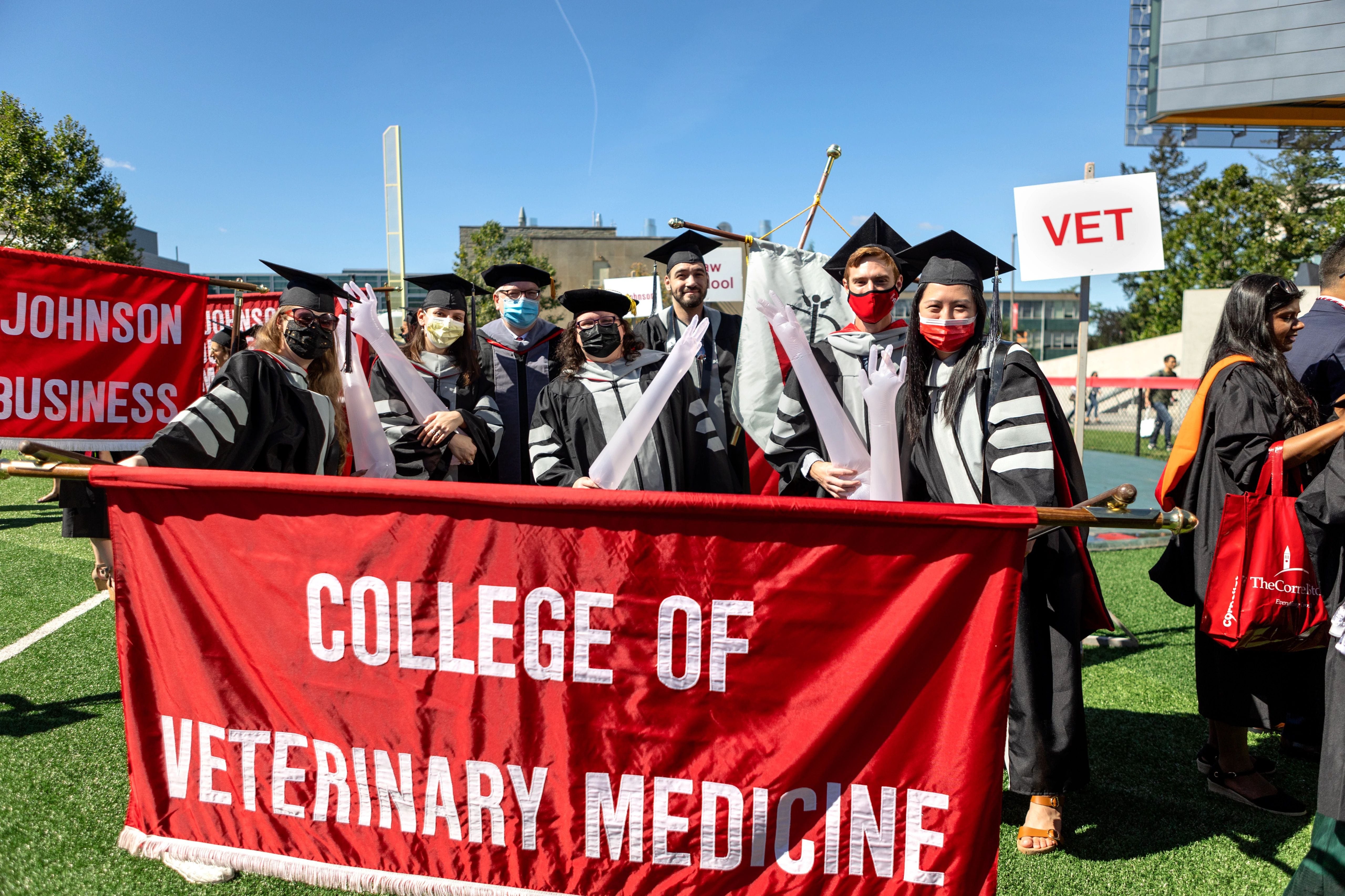 DVM grads carry their banner at commencement
