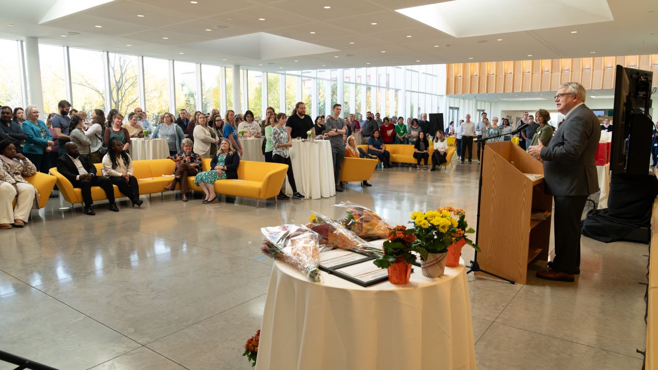 Dean speaking at a staff event