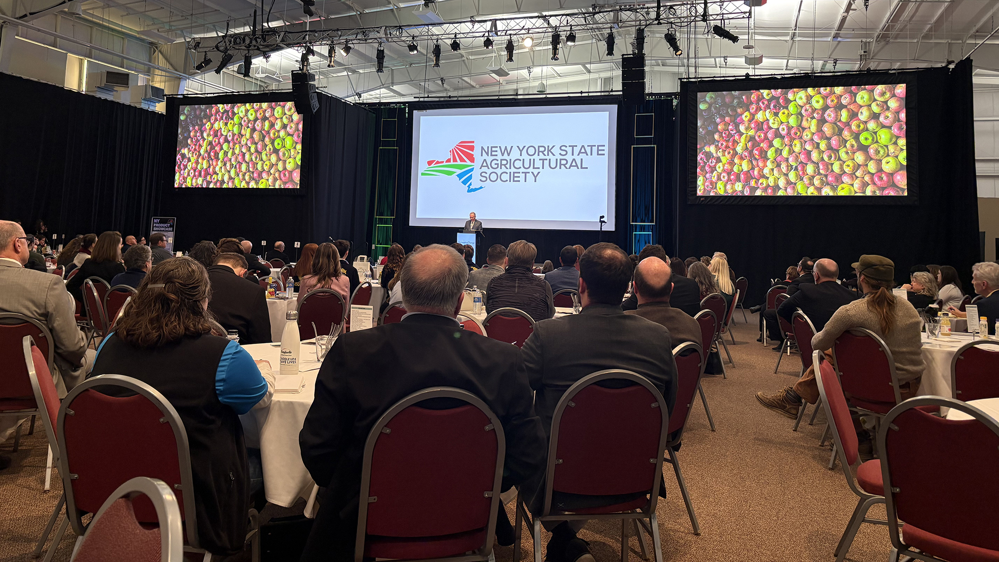 Commissioner Ball gives a speak in a full banquet hall for the ag forum