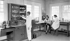 QMPS technicians in lab coats in an old 1948 lab