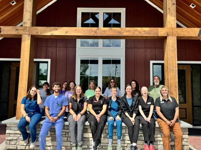 A group of shelter medicine professionals sitting outside the Wayne County Humane Society