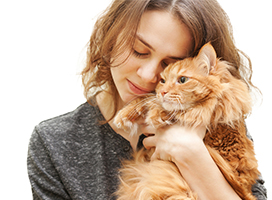 Woman nuzzling with orange cat