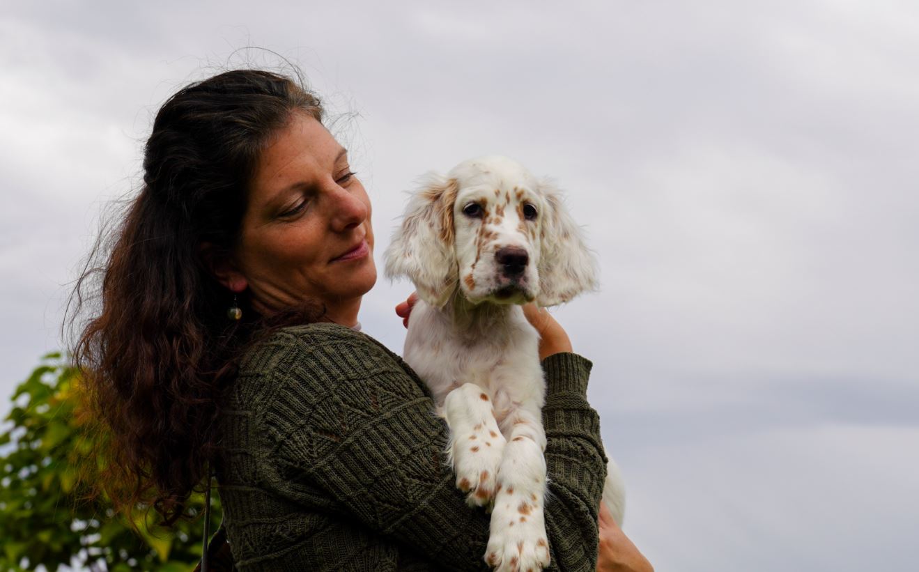 woman holding a puppy