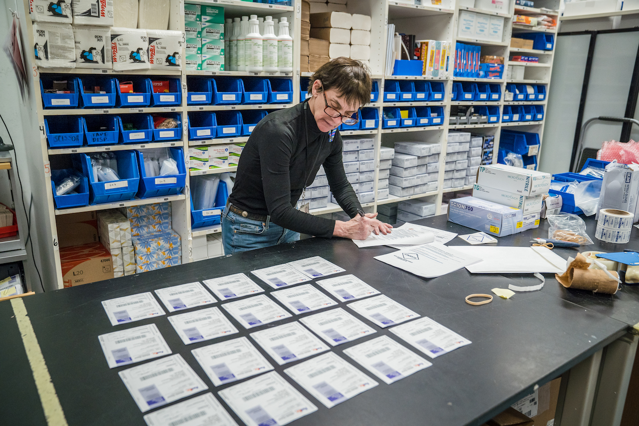 A woman examines a table full of UPS labels