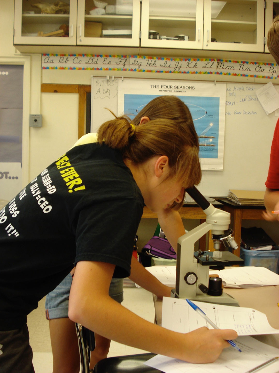 A student examines a tetrahymena cell beneath a microscope