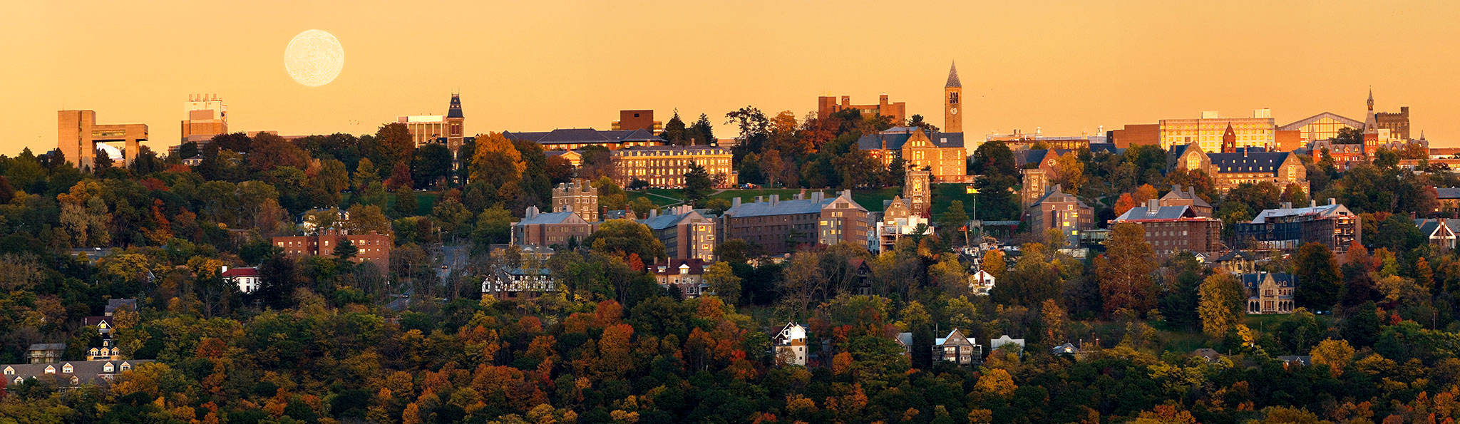 A panoramic of campus during an autumn sunset (with full moon rising) from the west hill.