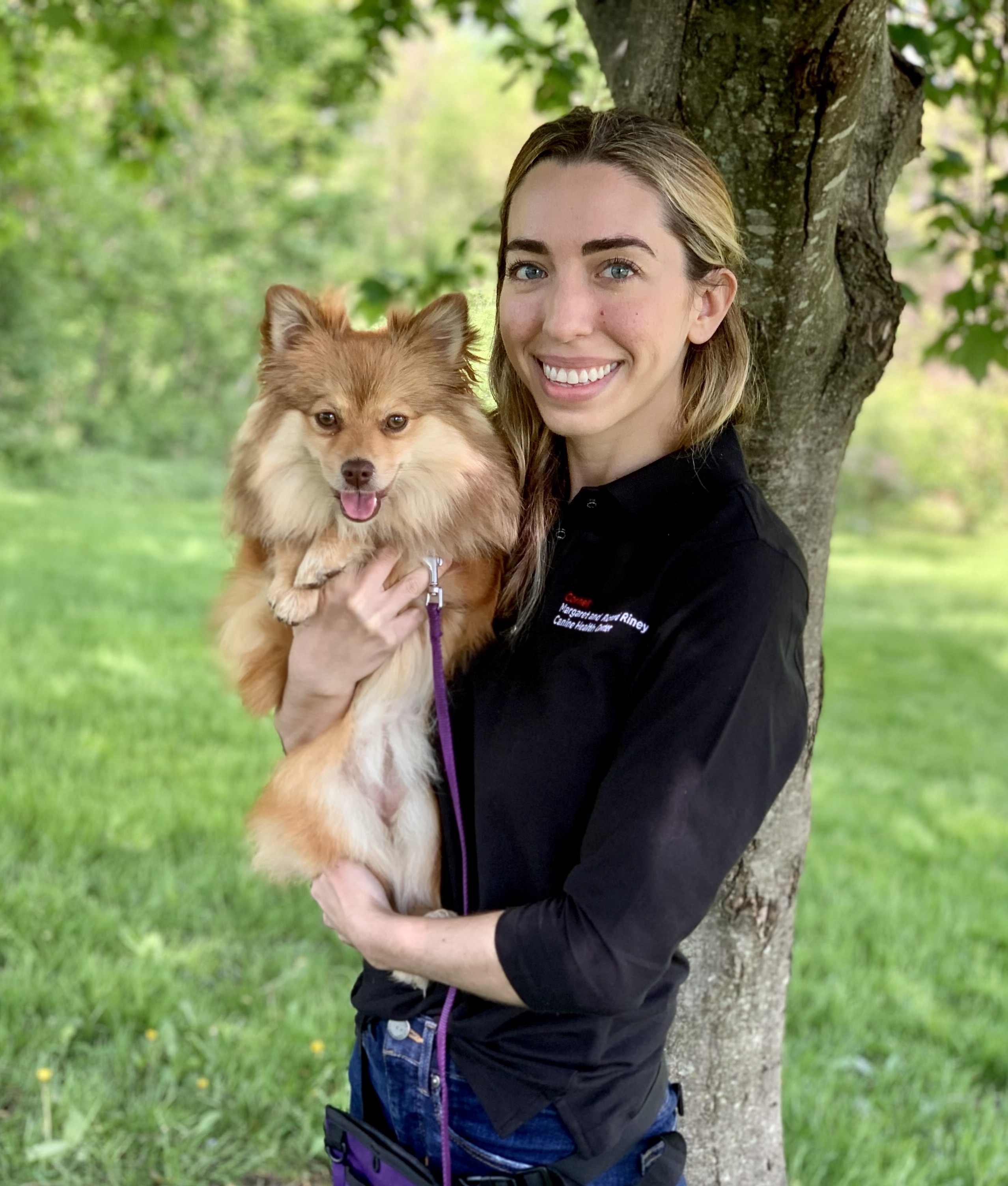 Aly Cohen holds a golden pomeranian