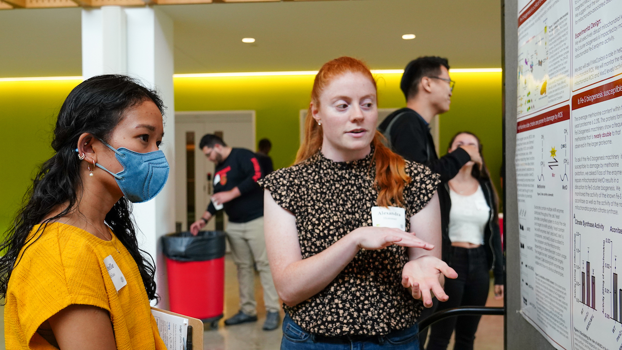 A student presents her work during the BBS poster session