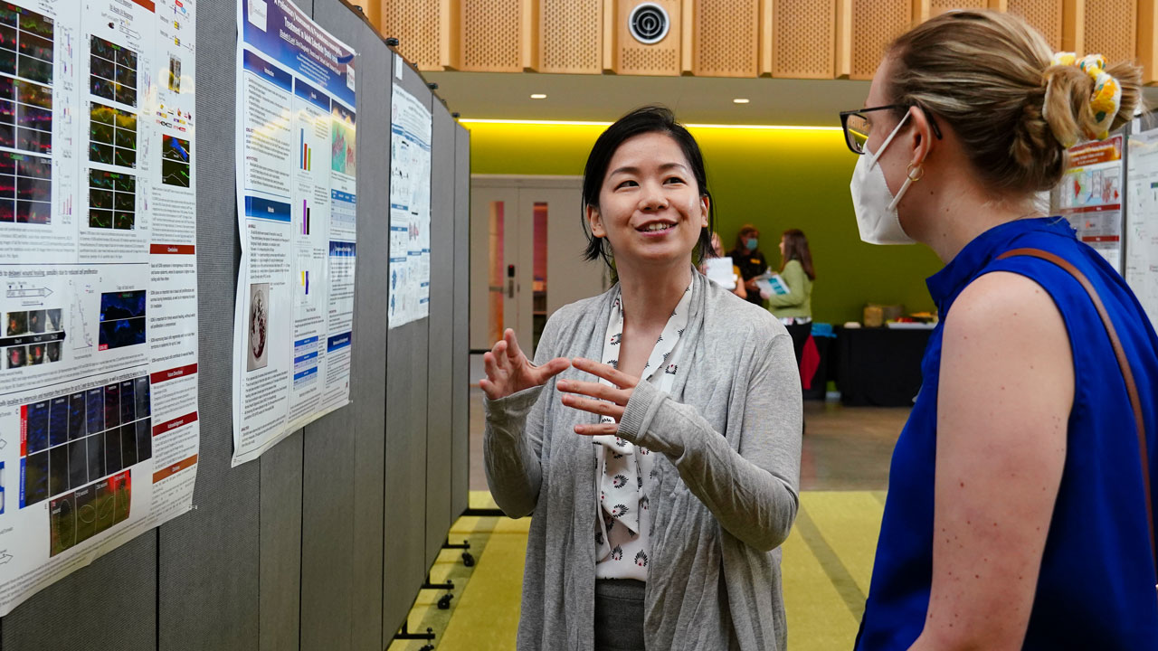 A student presents her work during the BBS poster session