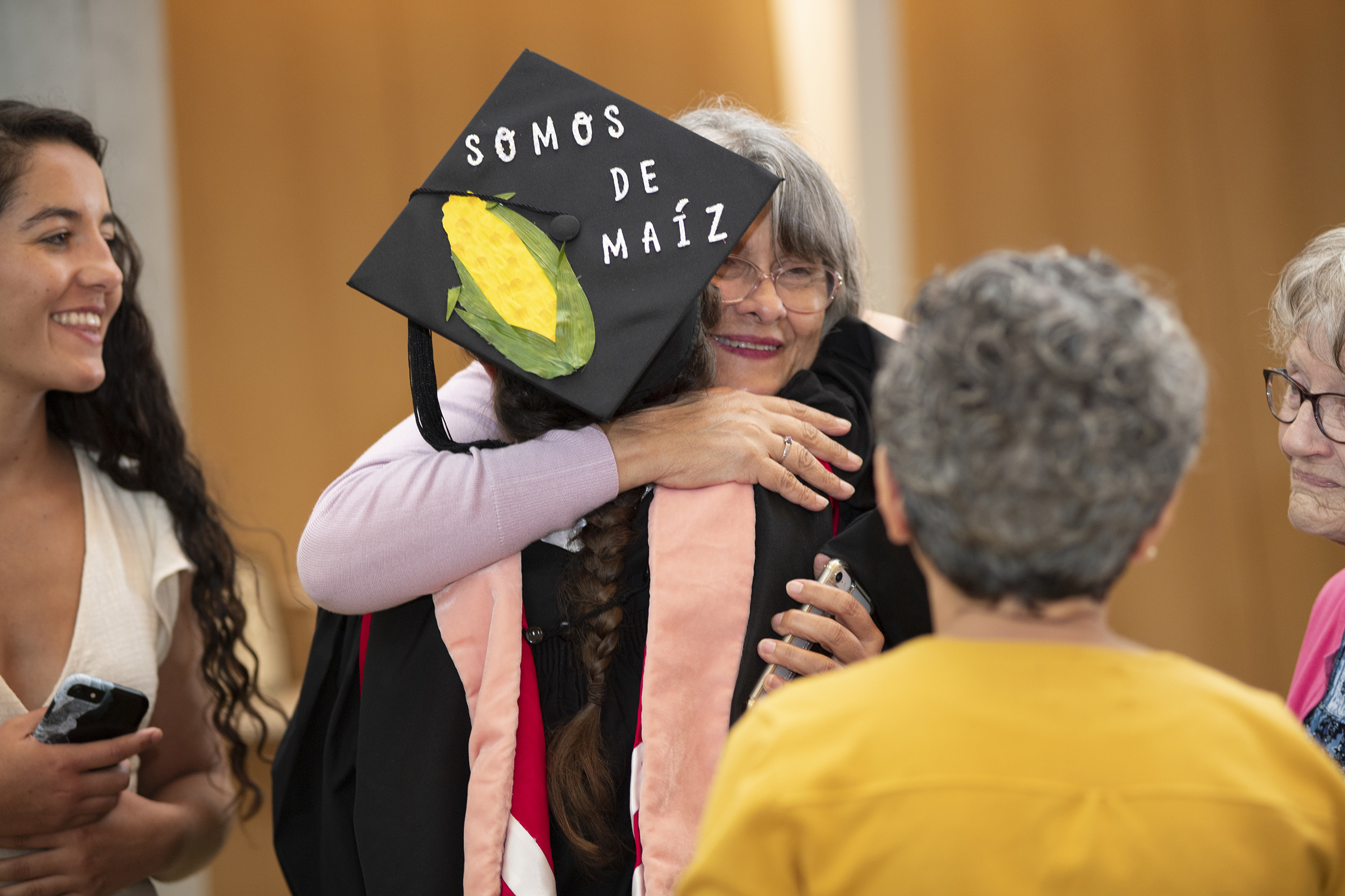 An MPH graduate hugging a family member