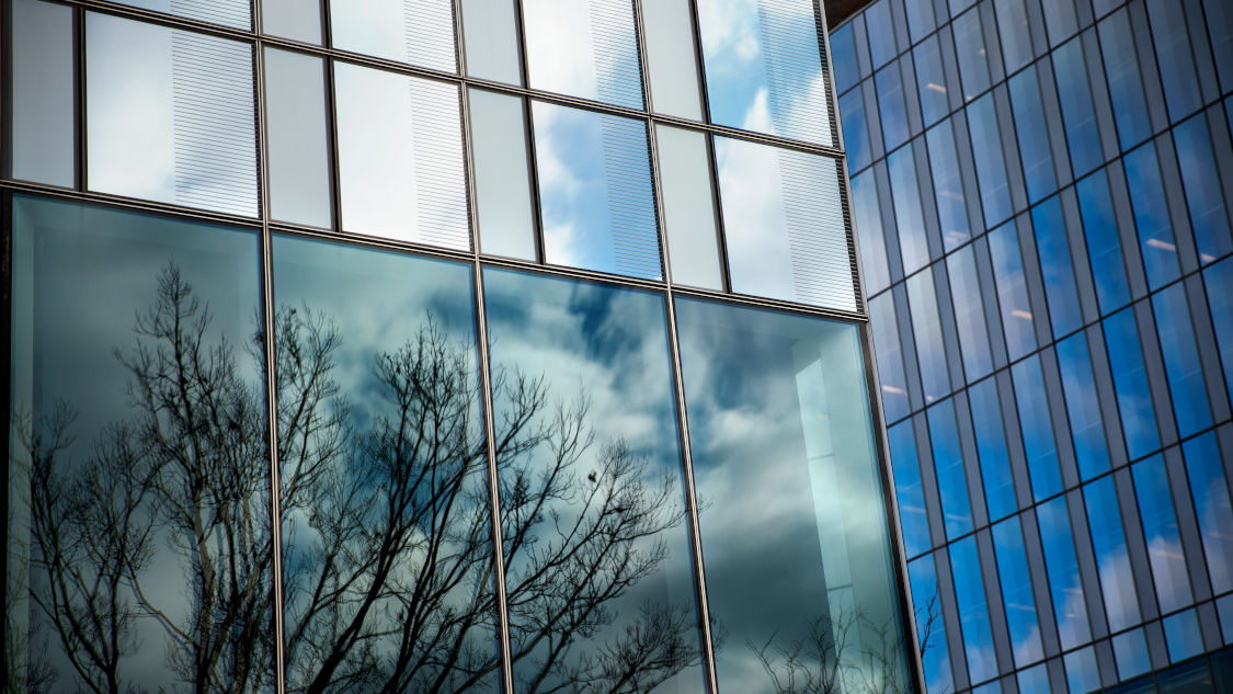 Windows of the CVM research tower reflecting a blue sky
