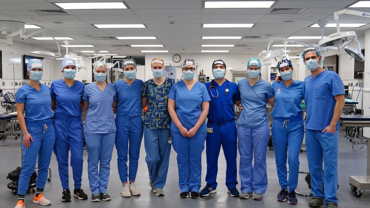 Ten veterinary students in scrubs, prepared to start the spay-neuter event