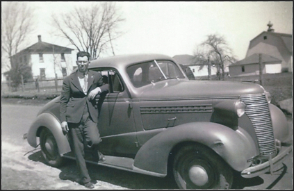 Dr. Samuel Bender poses next to a car.