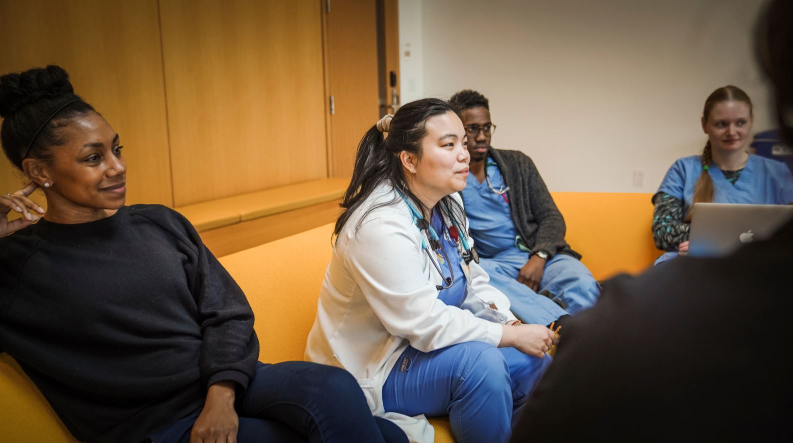 veterinary students sit together on yellow couches