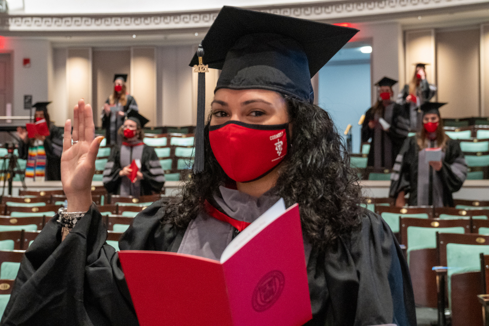 A veterinary student in cap and gown recites the Veterinarian's Oath