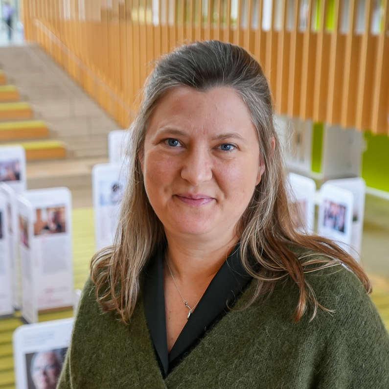 Dr. Kate Anderson stands in the vet college balcony overlooking the lobby