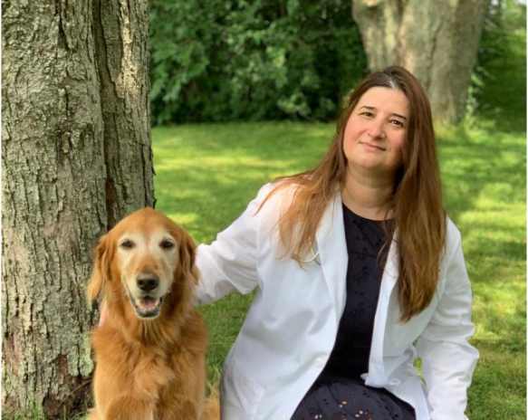 Dr. Marta Castelhano, director of the Cornell Veterinary Biobank, is Cornell’s principal investigator on this grant. She poses with Huckleberry Finn, a participant of the dog aging project.