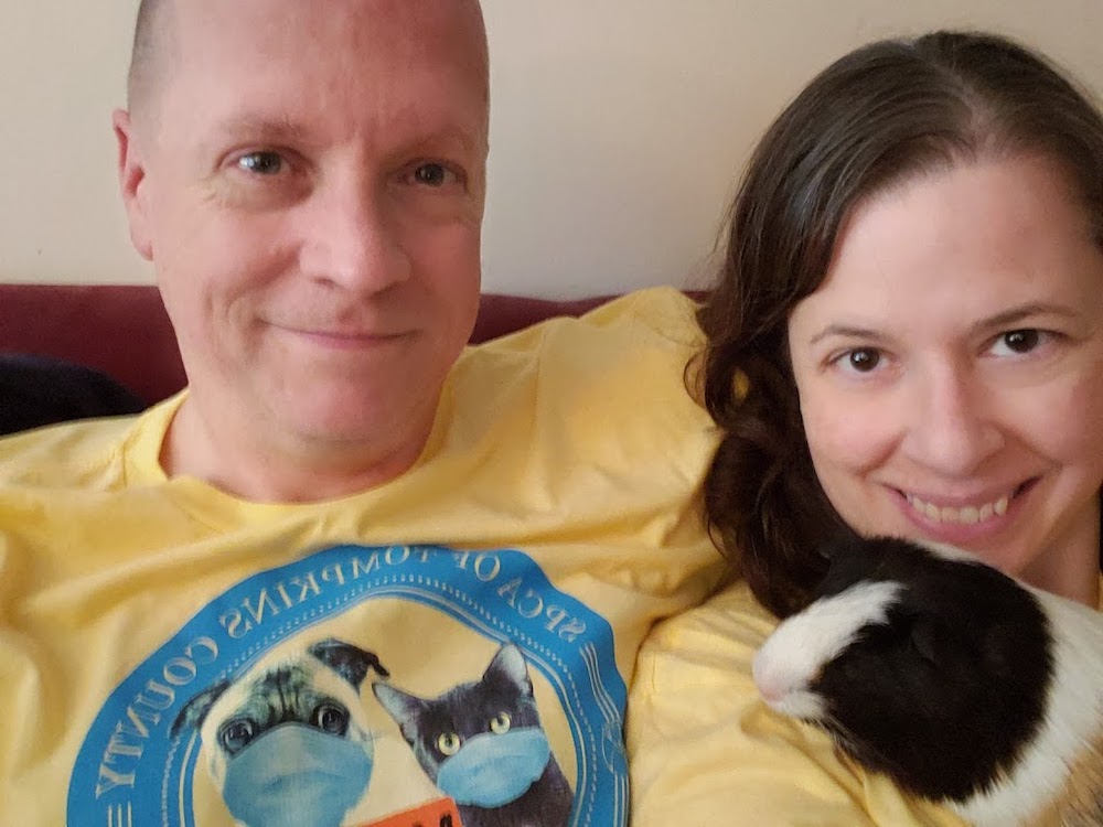 Chris Dunham and Melissa Travis Dunham hold Odin the guinea pig