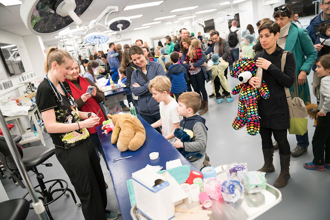 Student with children and stuffed animal