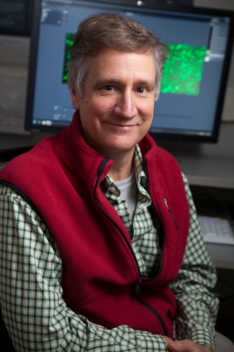 Scott Coonrod sits in front of computer in lab