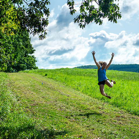 Woman jumping in a meadow