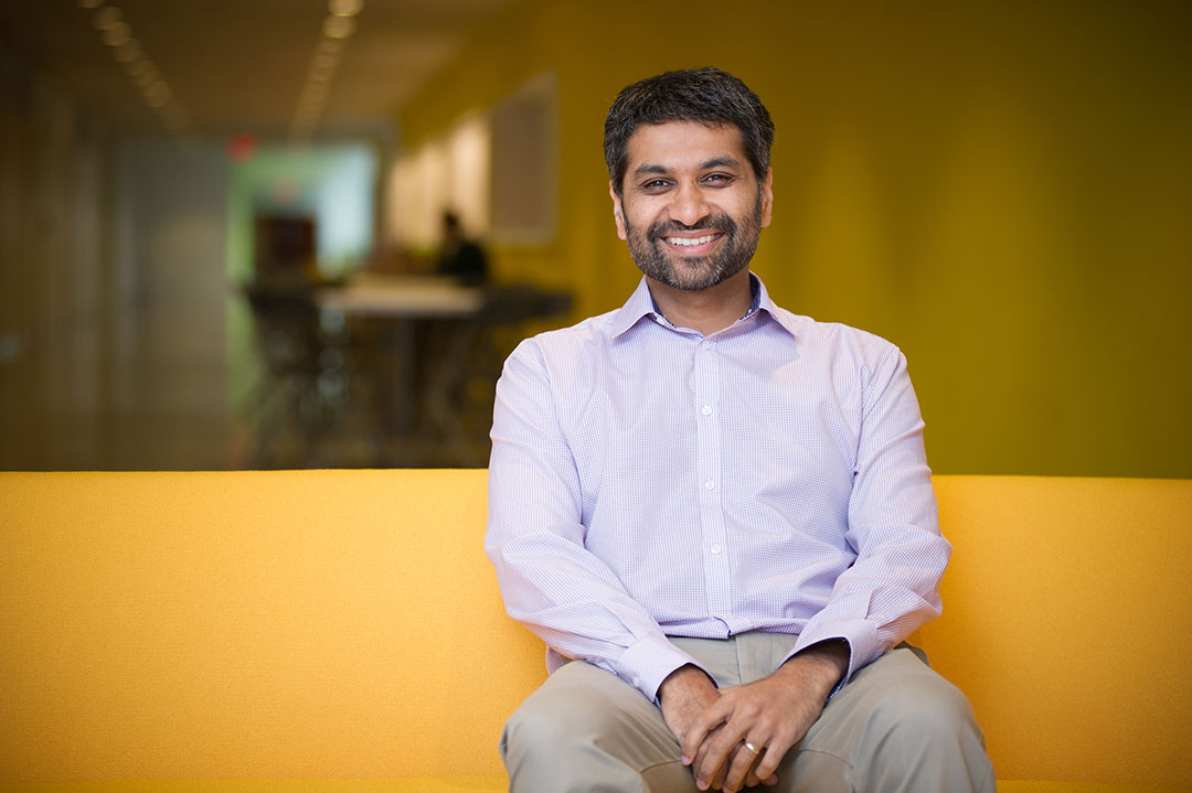 Dr. Praveen Sethupathy sitting in the CVM atrium