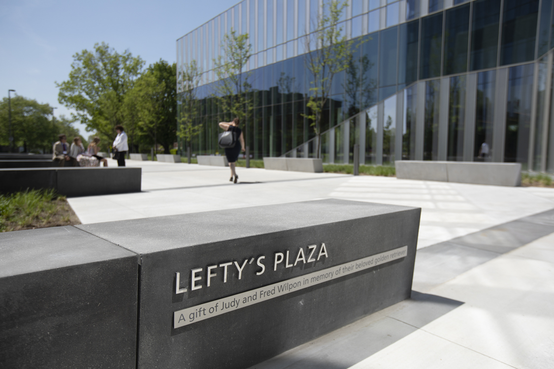 A shot of the sign marking Lefty's Plaza, with the new building in the background