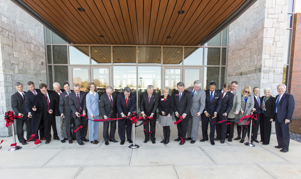 Members of the University of Georgia cutting a red ribbon in front of the Veterinary Medical Center, PC UGA
