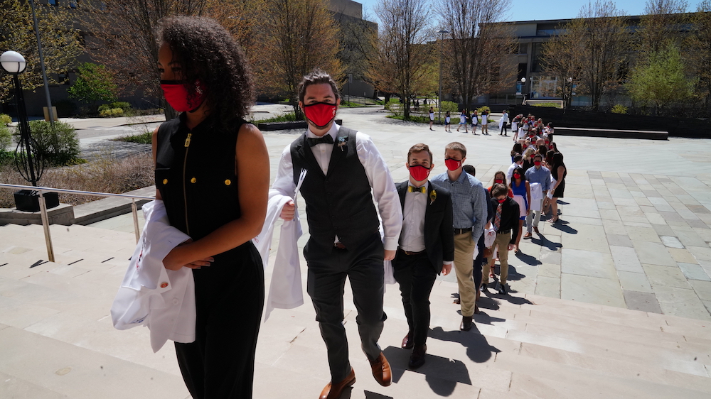 students lining up for white coat event