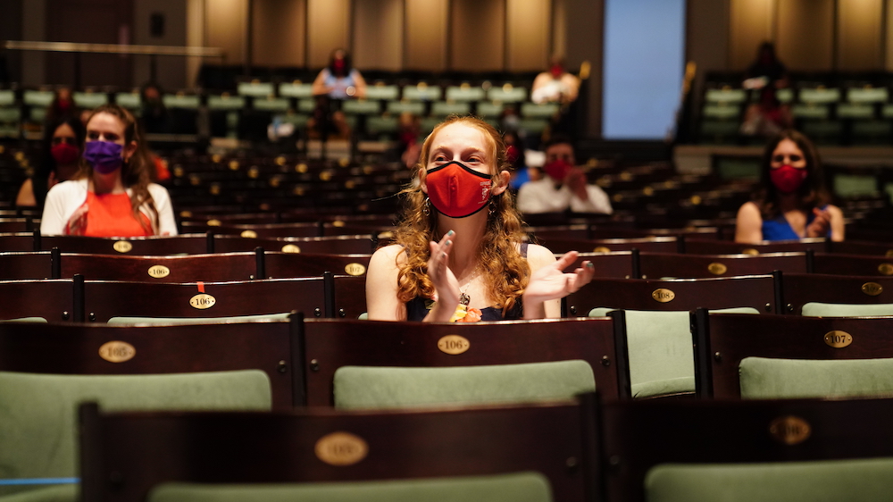 Students seated in socially distant places in Bailey Hall, wearing masks