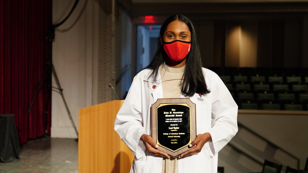 Laci Taylor holds the plaque announcing her win of the John F. Cummings Memorial Award