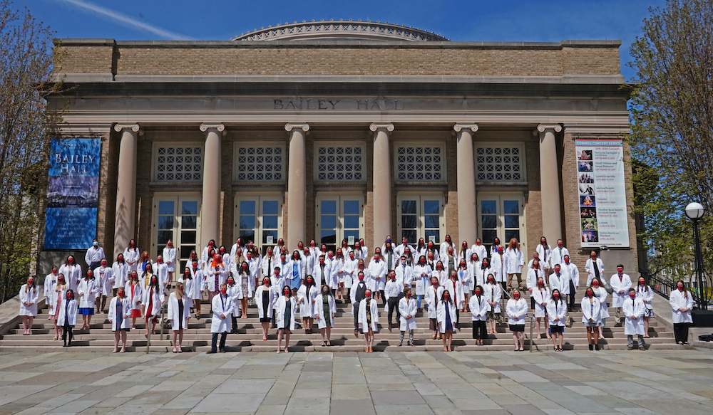 Third-year veterinary students standing socially distanced outside of Bailey Hall for a class photo