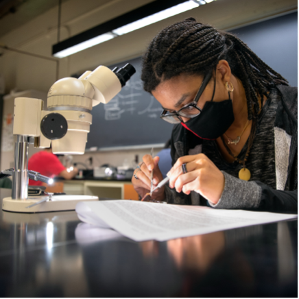 student at microscope 