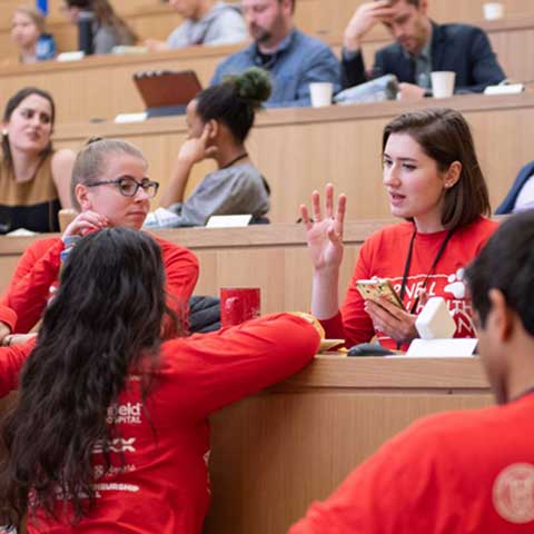 Students sitting in a lecture hall collaborating during the Animal Health Hackathon