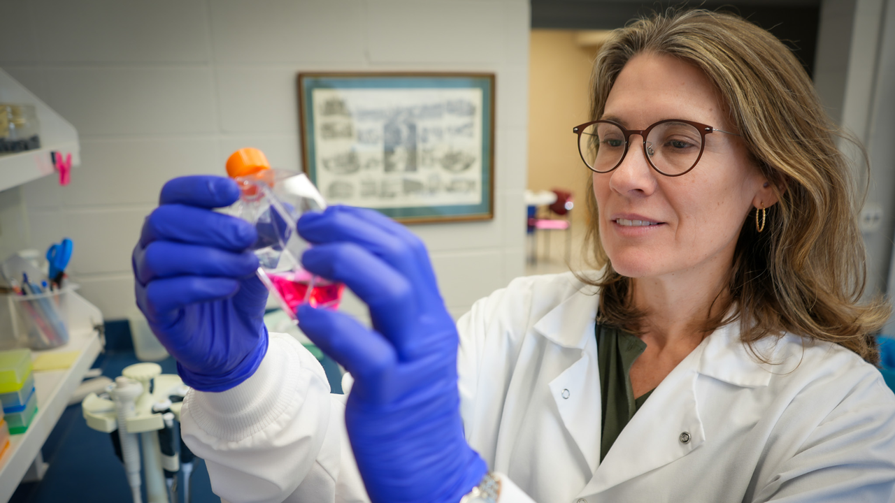 Dr. Mandi de Mestre examines a tube in the lab