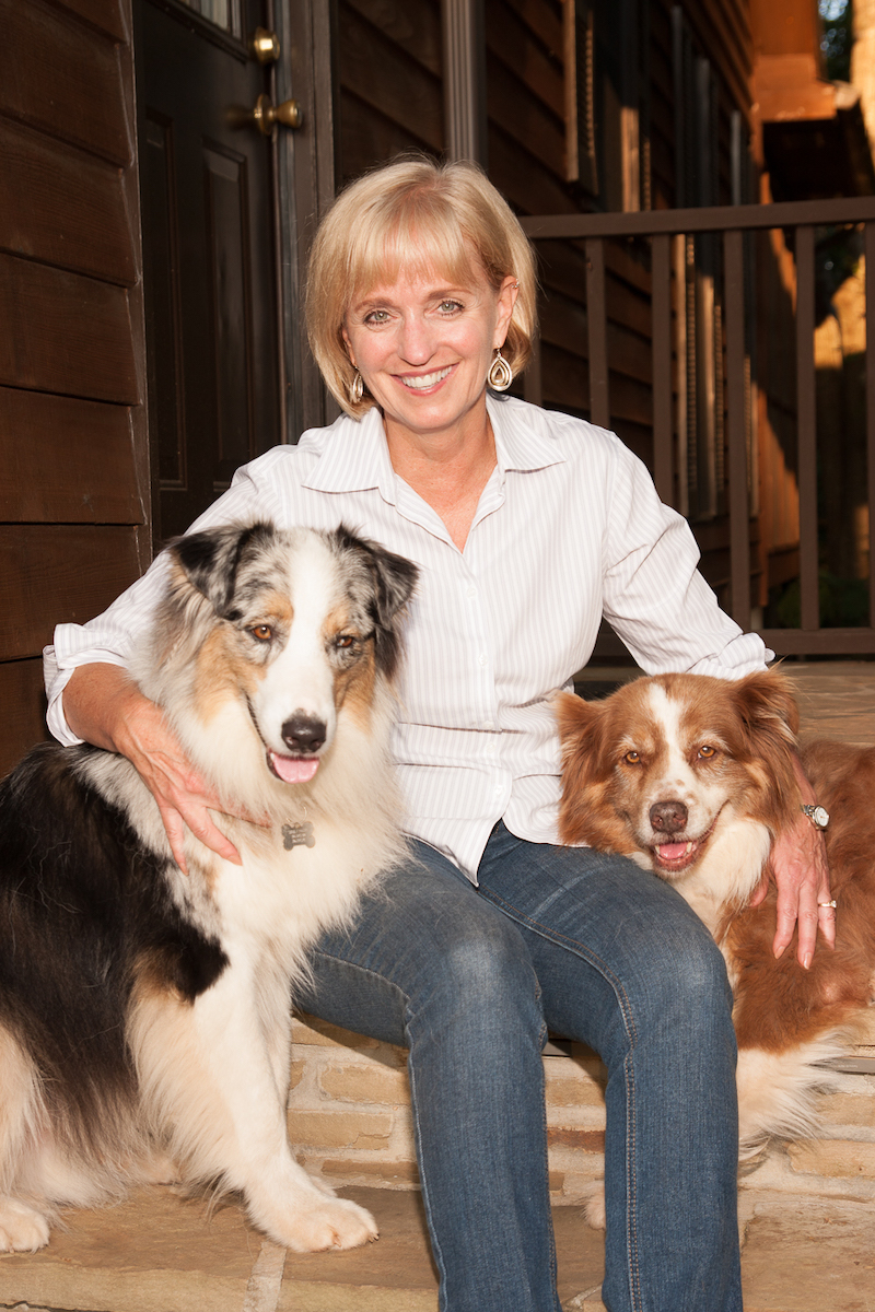 Sheila Allen seated with two dogs PC Susan Smith