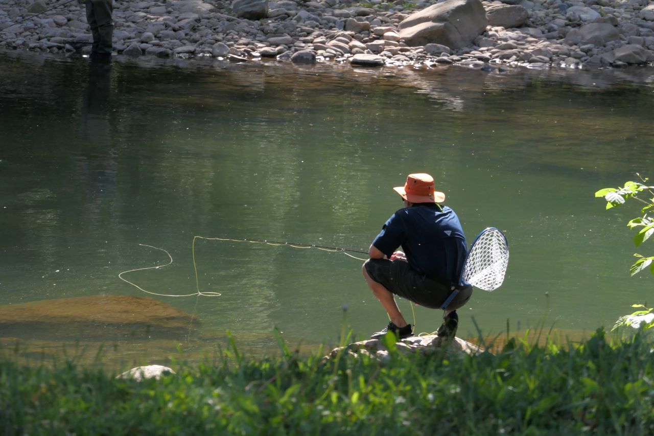 Man fishing by a river