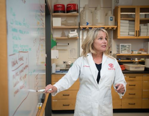 A doctor in front of a white board