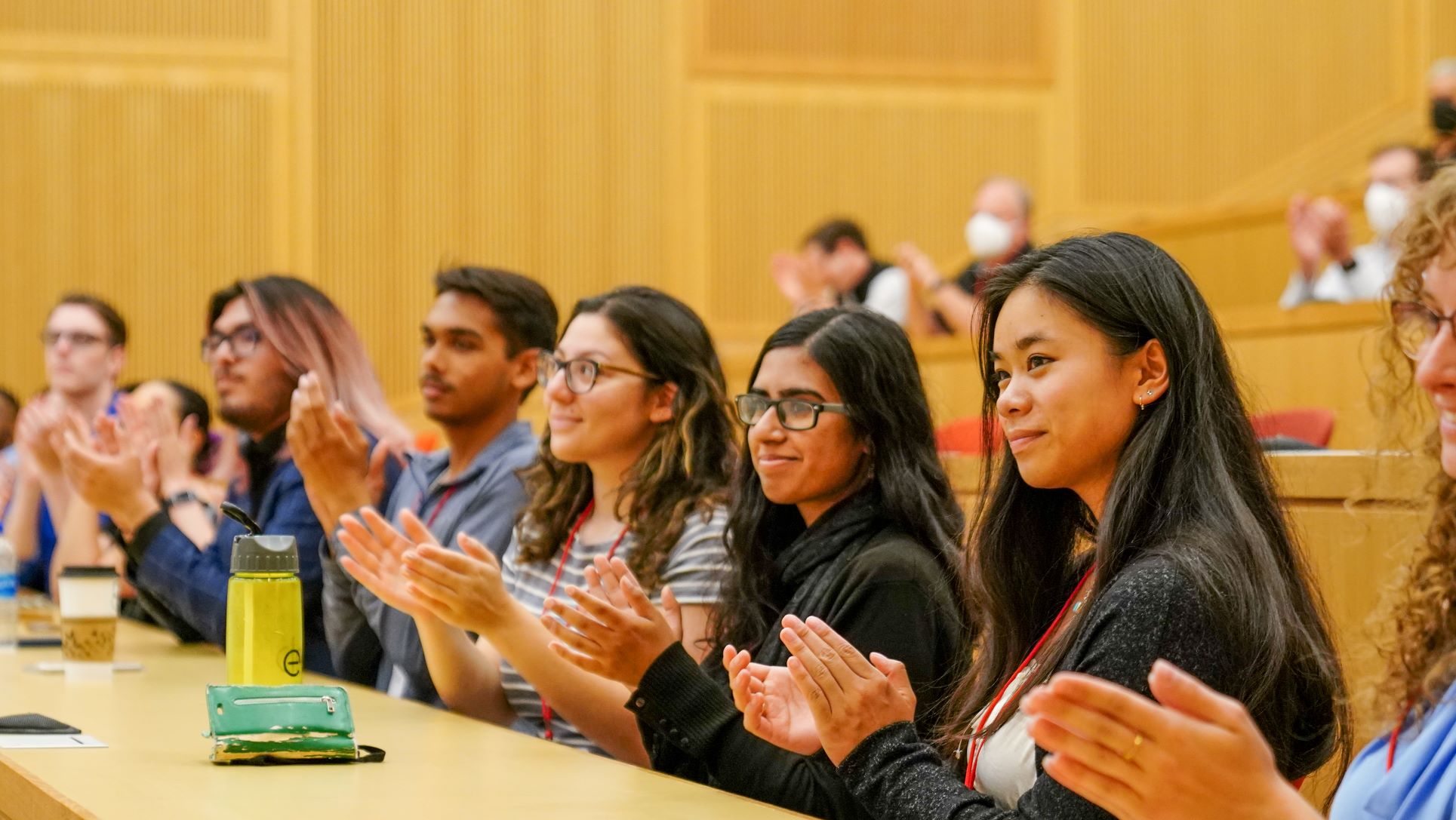 Students clapping in auditorium