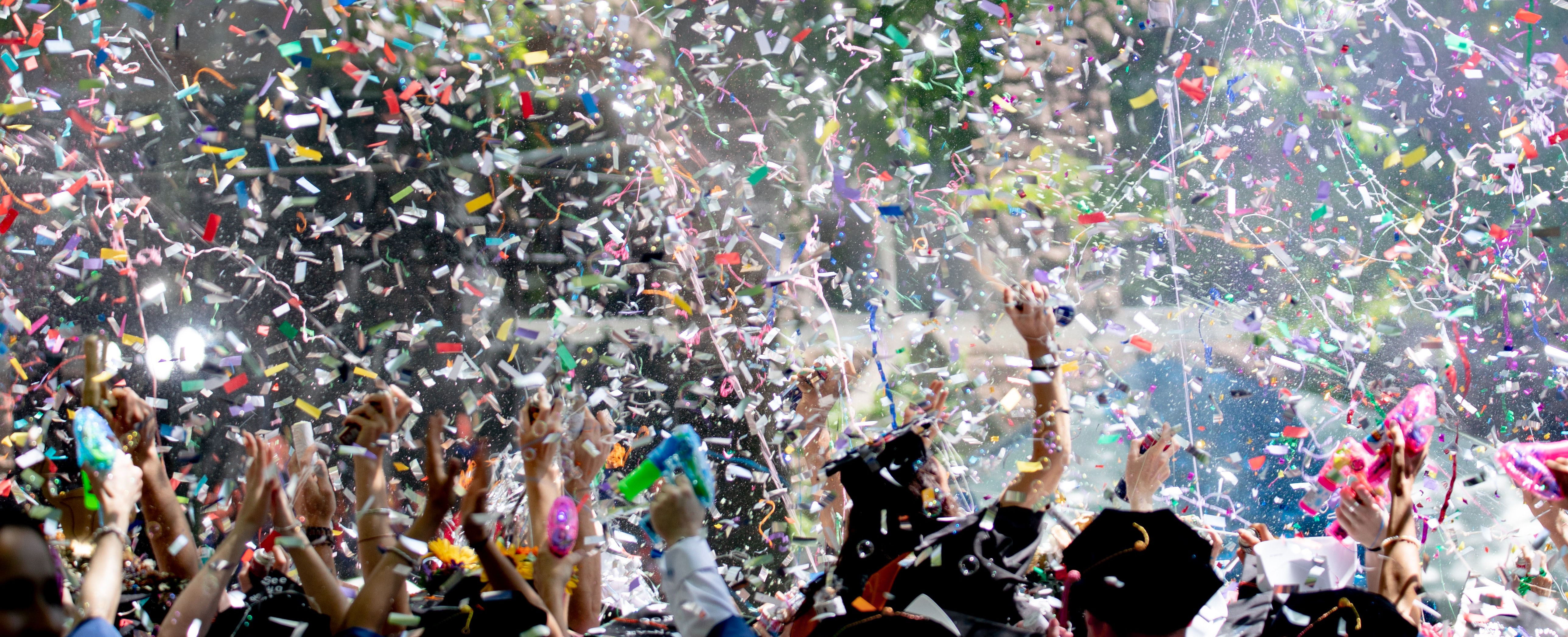 Graduates throwing confetti