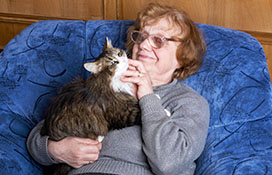 Older woman cuddling with cat