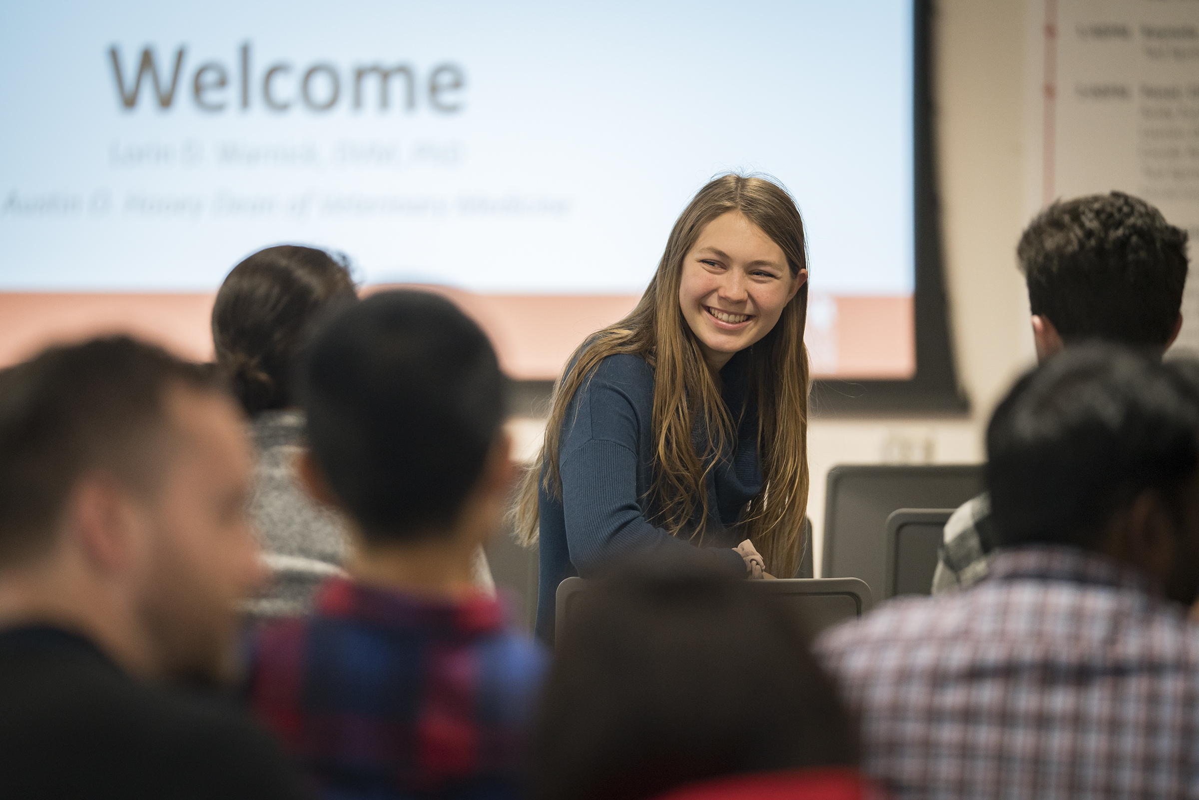 A student talks to others before the opening remarks at the 2018 animal hackathon.