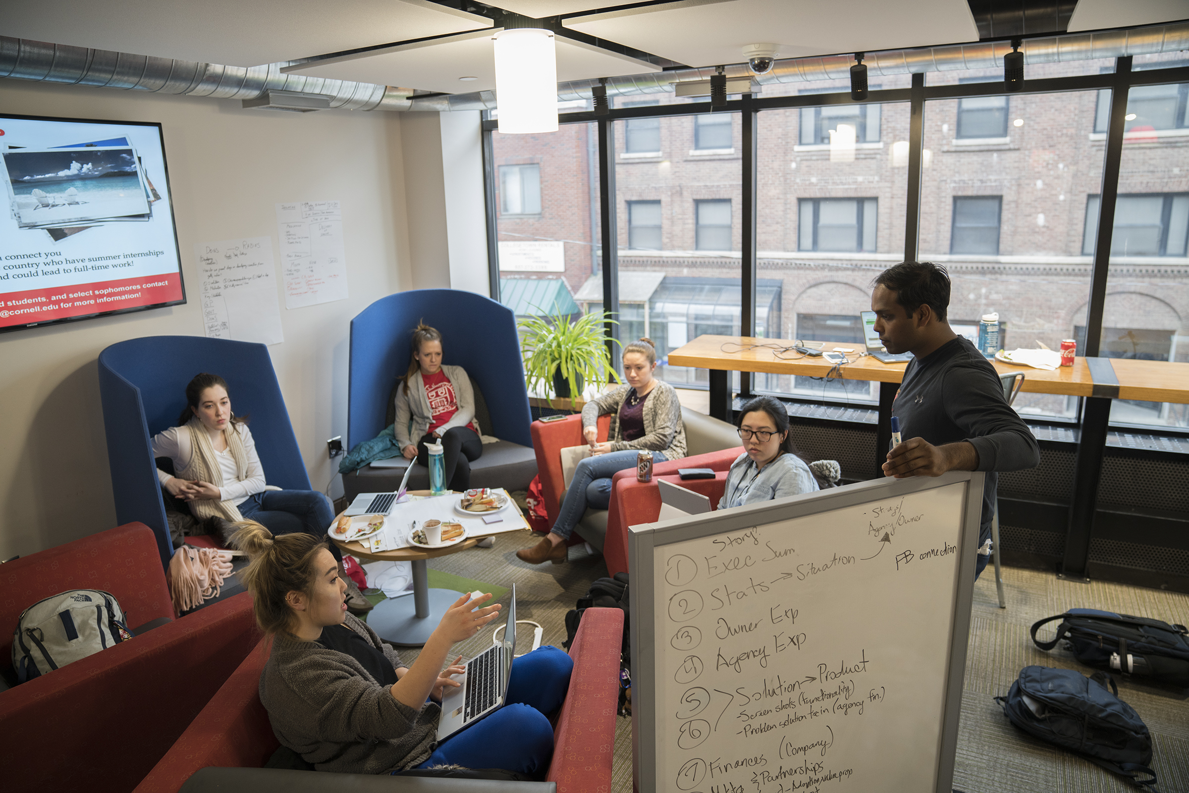 A team works to develop their idea at the hackathon.