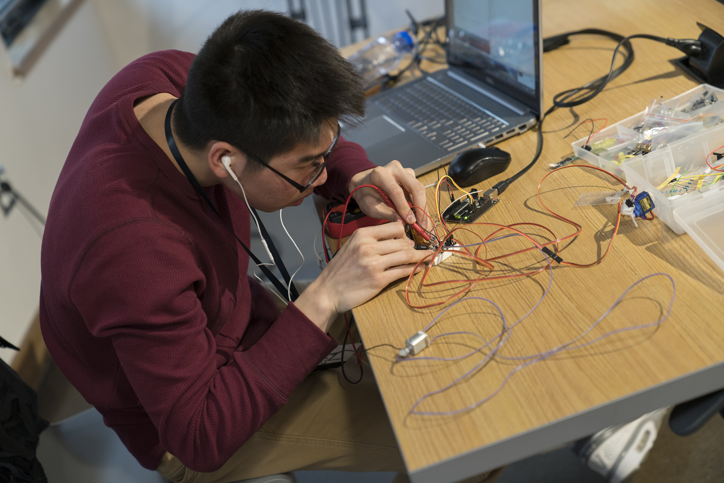 A student creating a prototype at the hackathon