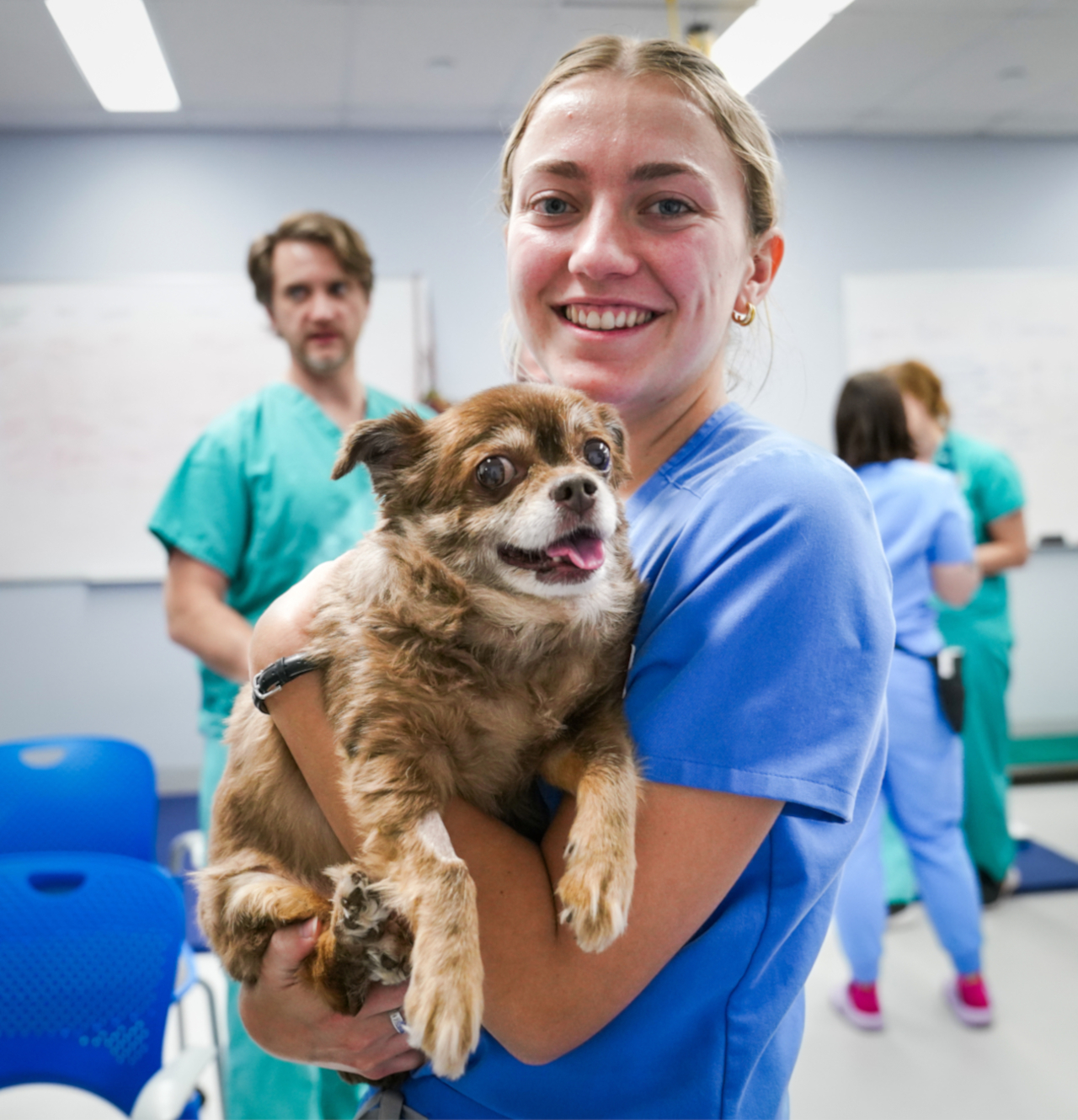 Student holding a dog