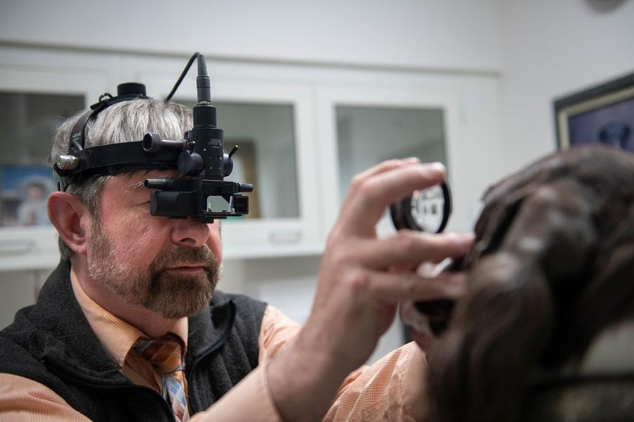Dr. Thomas Kern performing an eye examination