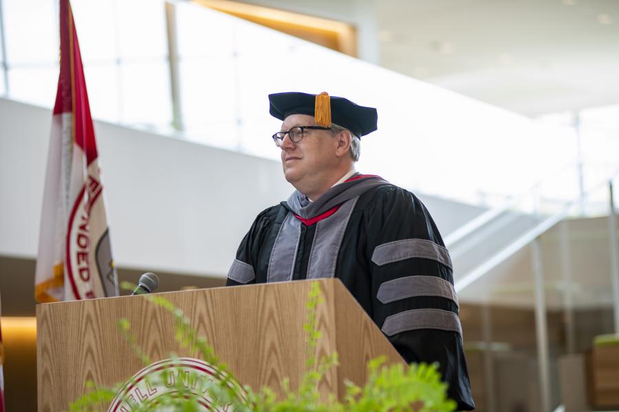Dean Warnick at a podium during the MPH hooding ceremony